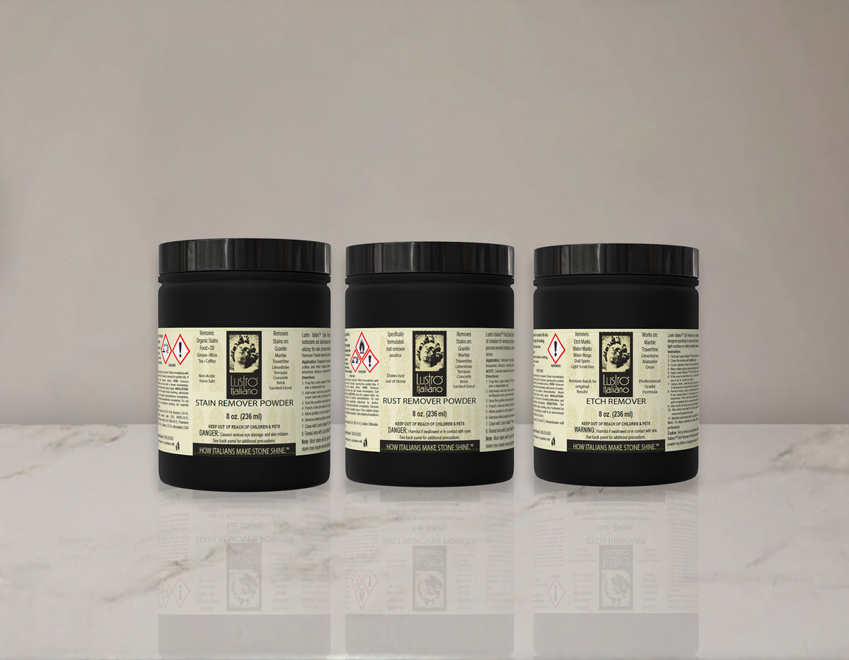 Three black jars with labels on a white surface